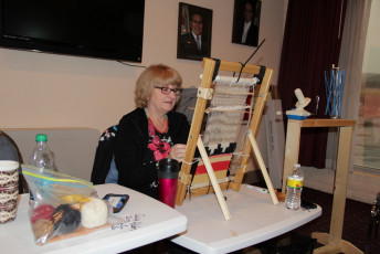 This view of student Bonnie Weaver shows the back of the loom with the warping blocks in place. 