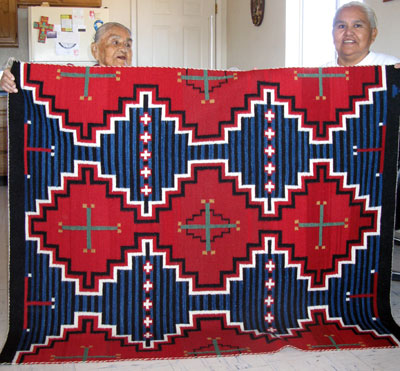 Weaver Jennie Slick (right) and her mother Anna Ashley show a Third Phase Chief Blanket that Jennie completed last winter. 