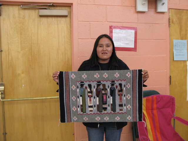 Weaver Ursula Begay show one of her Burnham style weavings prior to a Crownpoint rug auction in September of 2007