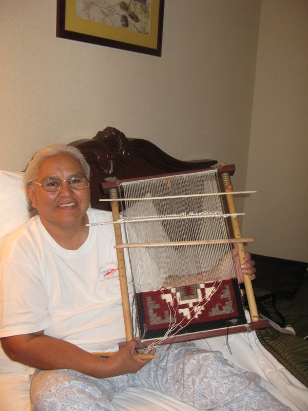 Jennie Slick with the Ganado Red weaving that she's doing on her C-Cactusflower loom. 