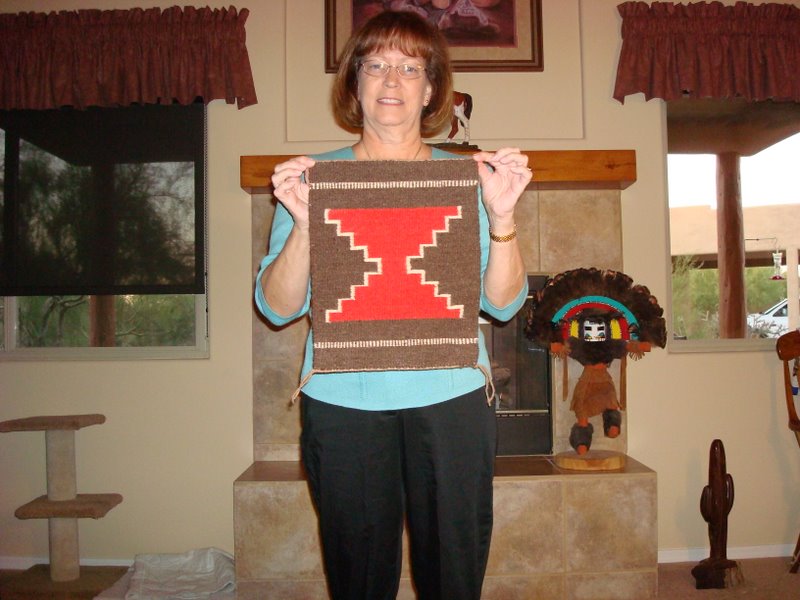 Jan Souders with her completed rug, which features outlined interlock joins. 