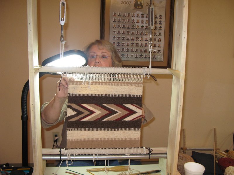 Diane Craig works on the last two inches of her weaving.  