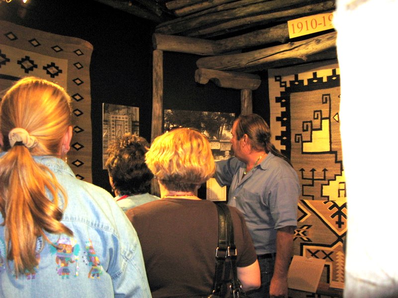Mark Winter of the Toadlena Trading Post and Rug Museum shows the students through the Master Weavers exhibit.  