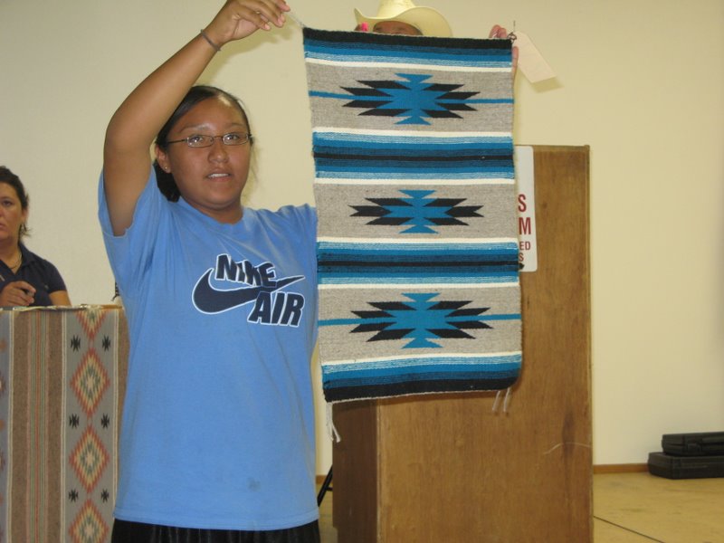 Devona Salake sells a weaving at auction.   Weaving Worlds documents the complexities of Navajo weaving in the modern world.