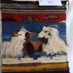 A Navajo-Churro sheep and an Angora goat explore each other's secrets in Roy Kady's textured weaving.