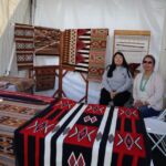 Charlene Laughing and her daughter with the wonderful designs produced by their family. They live and work in Crystal, NM.